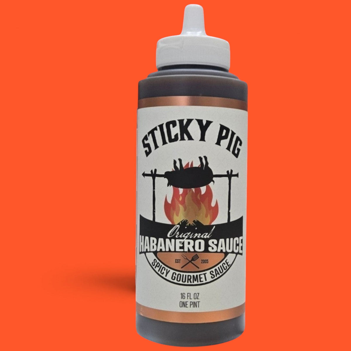 Sticky Pig BBQ Original Habanero gourmet spicy barbecue sauce in a 16-ounce squeeze bottle against an orange background