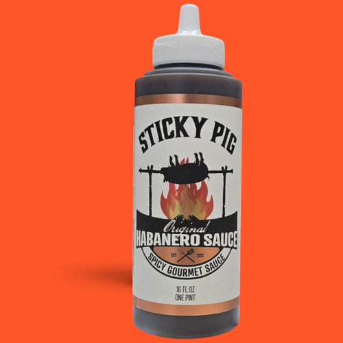 Sticky Pig BBQ Original Habanero gourmet spicy barbecue sauce in a 16-ounce squeeze bottle against an orange background