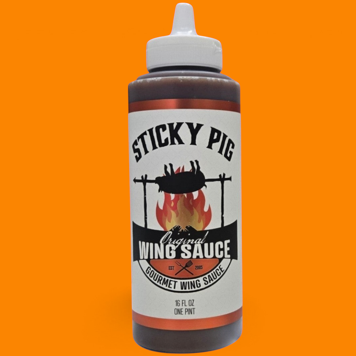 Sticky Pig BBQ Original Gourmet Wing Sauce in a 16-ounce squeeze bottle with a white cap against an orange background.