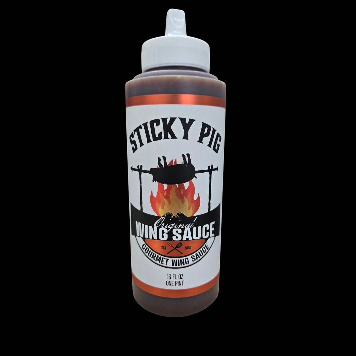 Sticky Pig BBQ Original Gourmet Wing Sauce in a 16-ounce squeeze bottle with a label featuring a pig over a fire.